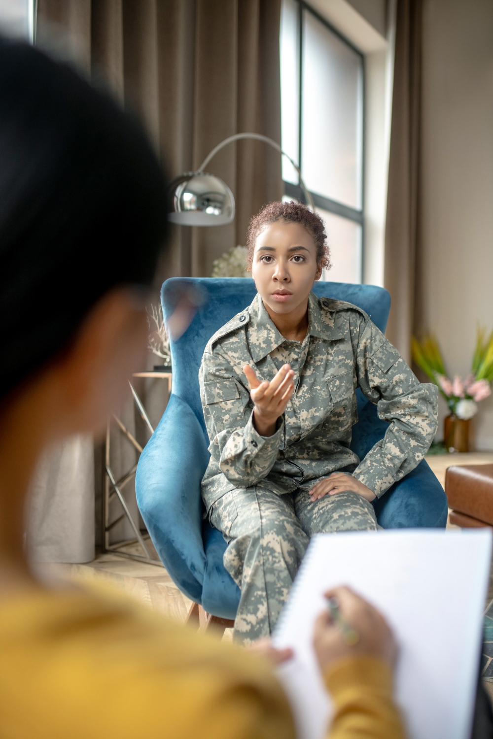 young woman veteran speaking with therapist